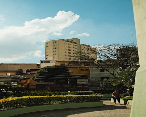 Woman walking peacefully in a green residential park in Heredia