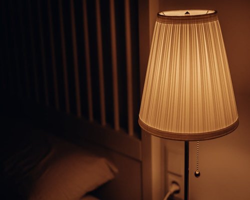 Cozy bedroom setting with soft warm lighting for evening rest
